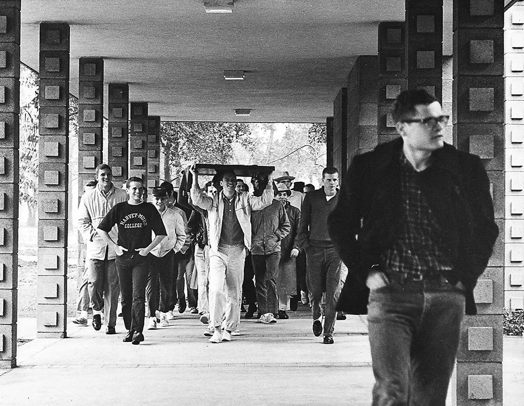 Students walking in covered walkway with stolen office door.