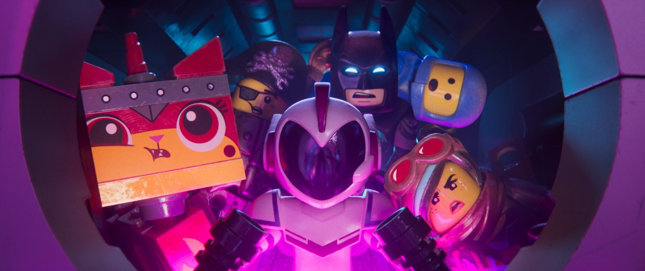 Still from The Lego Movie 2: The Second Part. Assorted characters looking out of a portal.