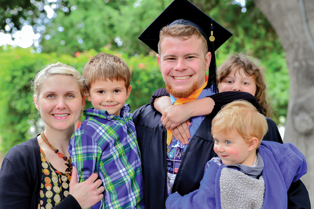 Roger Hooper in graduation robes with family.