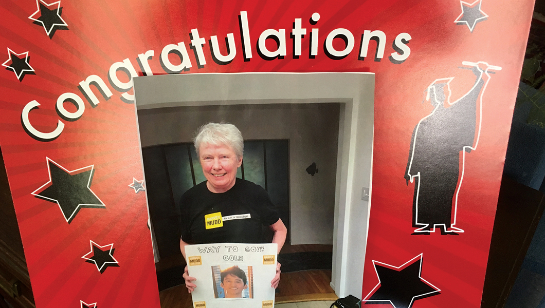 Maria Klawe holding congratulations sign for Cole Kurashige