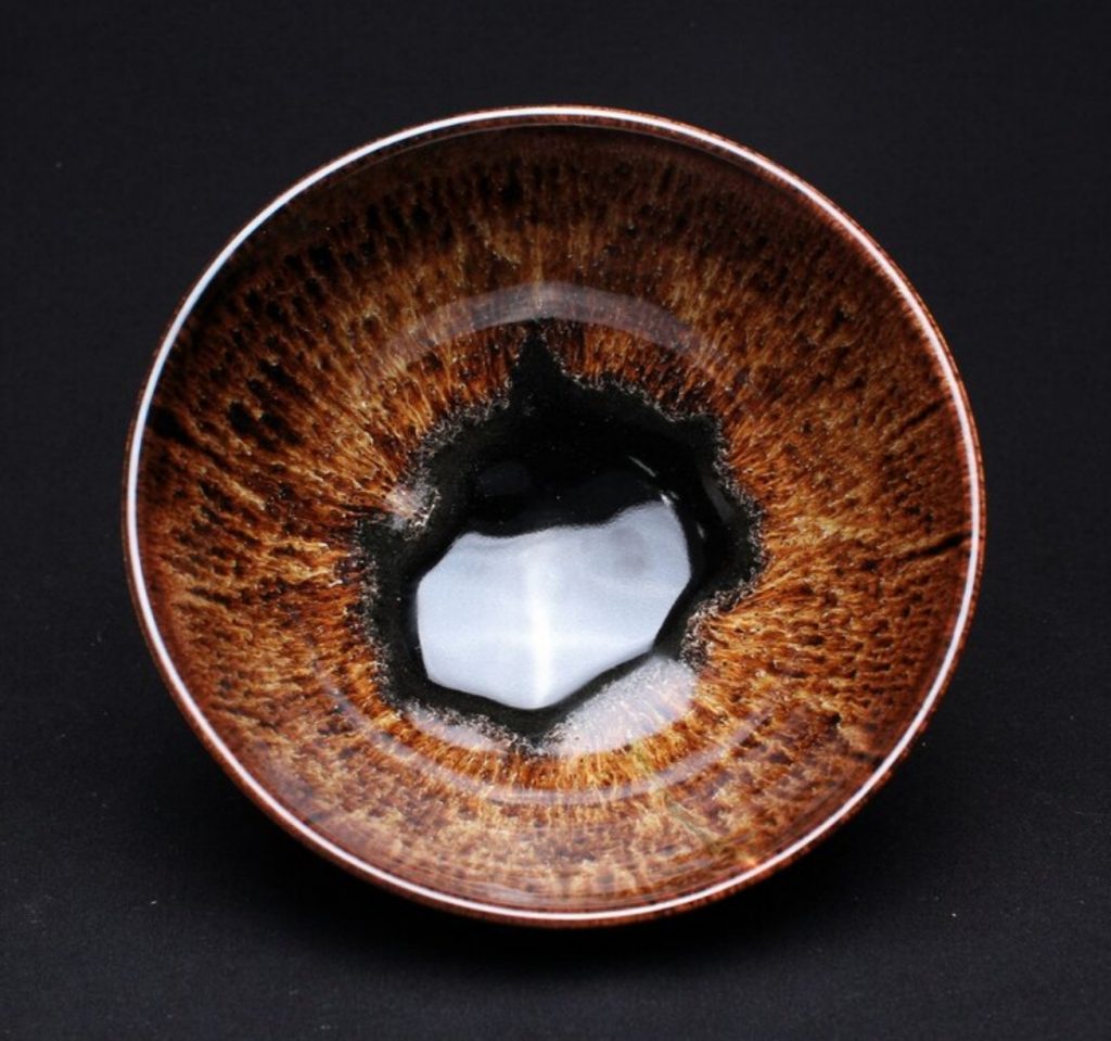 Brown patterned glazed bowl from above.